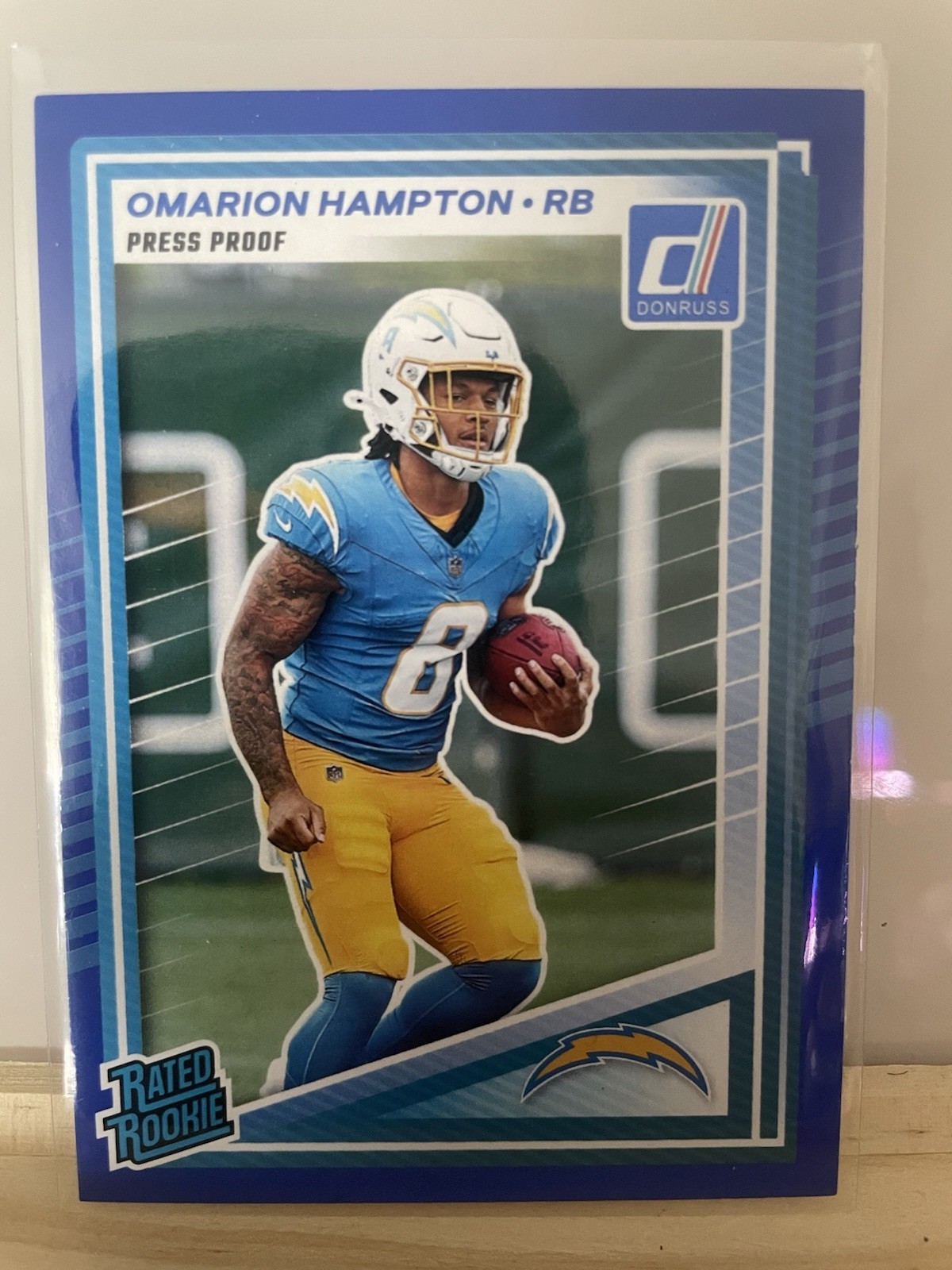 Panini Donruss 2025 Rated Rookie Press Proof Blue Omarion Hampton #303 Chargers