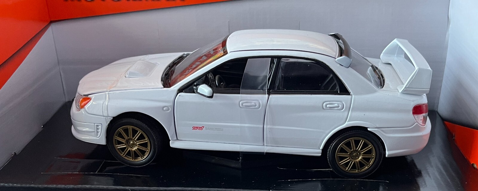 Subaru Impreza WRX STi in white, 1:24 scale diecast car model from Motormax