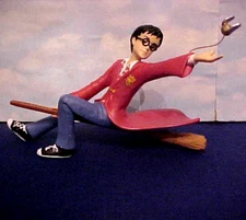 Harry Potter on Broom Flying and Reaching out to catch the golden Snitch