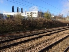 Photo 6x4 View from a Peterborough-London train - Industrial & retail uni c2017