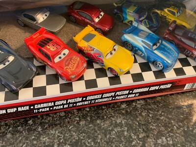 DISNEY CARS PISTON CUP RACE 11 PACK GEORGE NEW-WIN, JONAS CARVERS