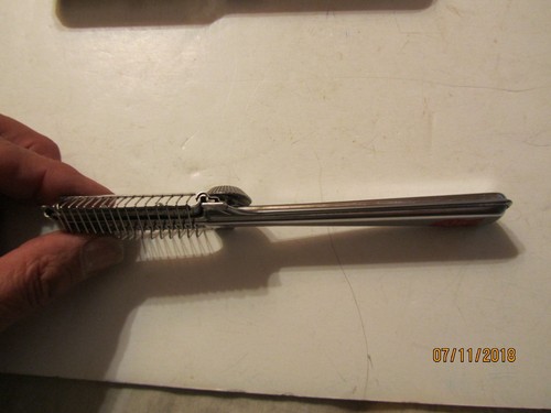 Silver vintage Playtex hair cutter with textured handle and engraved oval case, made in USA on 07/11/2018.