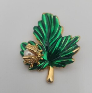 Vintage gold tone rhinestone LADYBUG beetle on green enamel LEAF brooch pin