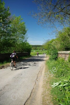 Photo 6x4 Heading for the A43 Tixover These cyclists were zooming out of  c2011