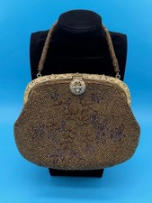 Vintage beaded handbag. Metal kiss-lock clasp closure and a beaded rope handle.