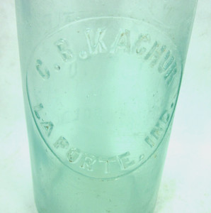 C.B. KACHUR LA PORTE INDIANA embossed slug plate blob topo beer bottle rim chip