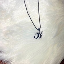 Necklace letter K in cursive writing black with rhinestones on a black chain