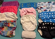 Set of 10 preowned-reusable cloth baby diapers from Alvababy and 3 otherbrands.