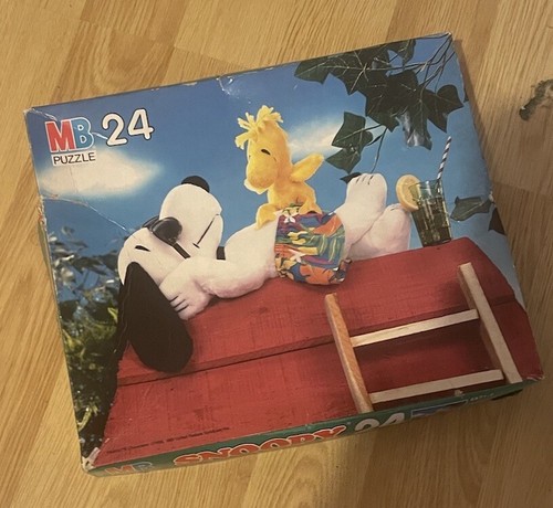 Vintage MB Puzzle 24-piece box featuring Snoopy in sunglasses relaxing on a wooden roof with a bird and green leaves.