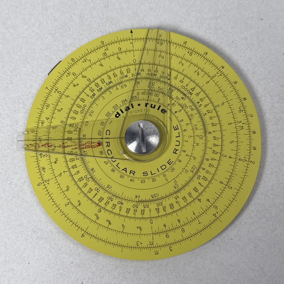 A USA-made Pickett circular dial slide rule — a working piece of American analog computing history that looks as good on a shelf as it is to actually use.