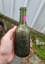 Short Green Liquor bottle with a seal that wa...