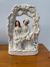 LARGE STAFFORDSHIRE FLATBACK COUPLE SEATED UNDER ARCH 14"