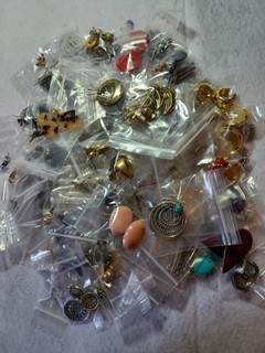 Huge lot of pierced earrings 100 in total. Many styles shapes sizes & colors.