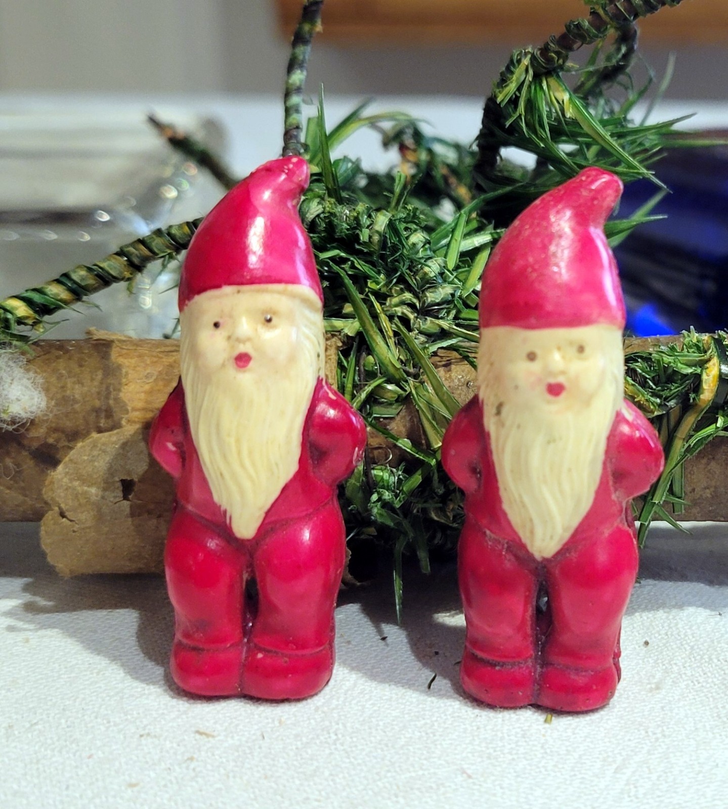 Two Miniature Celloloid red-dressed Christmas Elves. Japan. Hands behind Backs