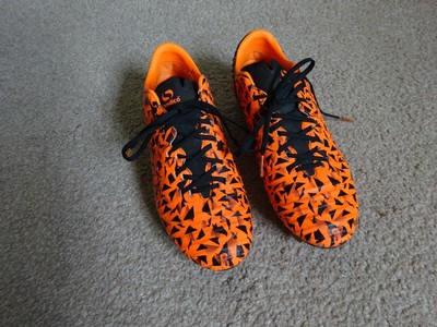 orange and black football boots