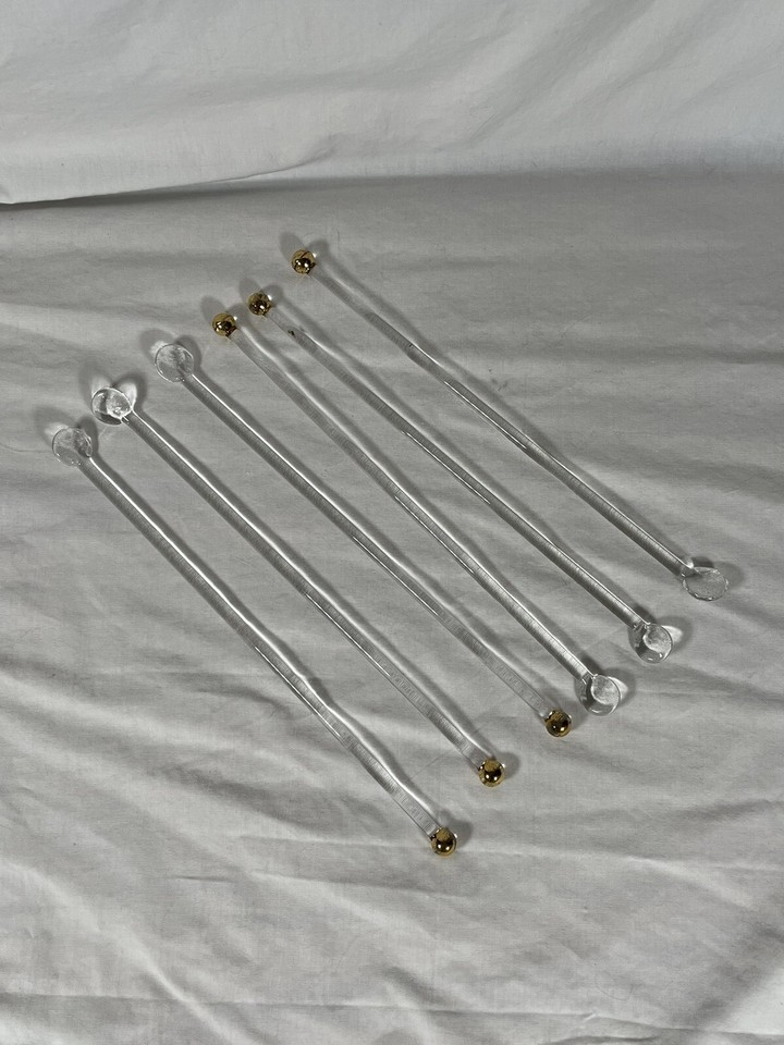 Sleek gold-tipped glass swizzle sticks are the quiet MCM flex that elevates a home bar from basic to intentional.