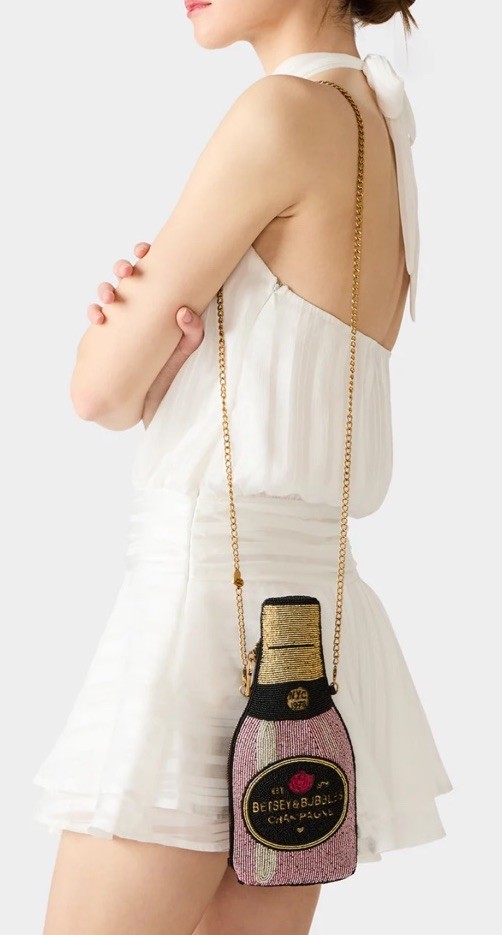 Betsey Johnson's maximalist beaded champagne-bottle crossbody is peak kitsch party accessory energy.