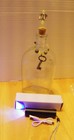 Vintage bottle w/ uranium and yooperlite accents & vintage clock key & UV light — photo 1