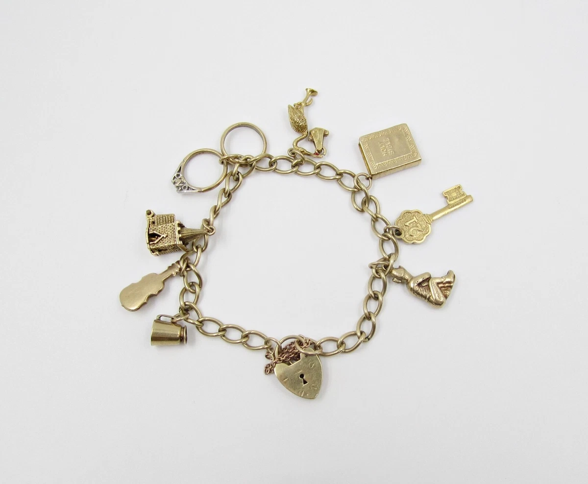 VINTAGE 9ct GOLD CHARM BRACELET WITH 8 CHARMS CHURCH BIBLE STORK RINGS KEY