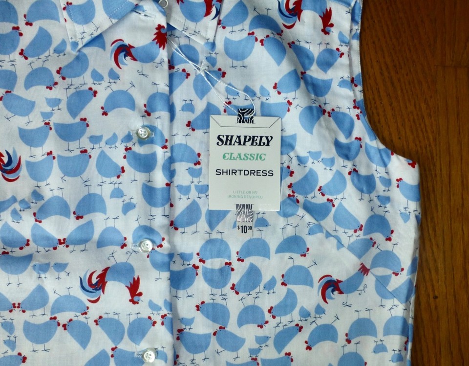 A deadstock 1960s novelty print shirt dress featuring hens and roosters — still-tagged vintage that's wearable art.