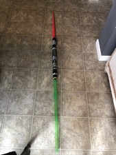 Double-Bladed Light Saber Green And Red. Green Lights Up Turns Into Two Sabers