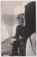 Lost in Thought Young Girl and Man Share a Quiet, Reflective Moment by the Water