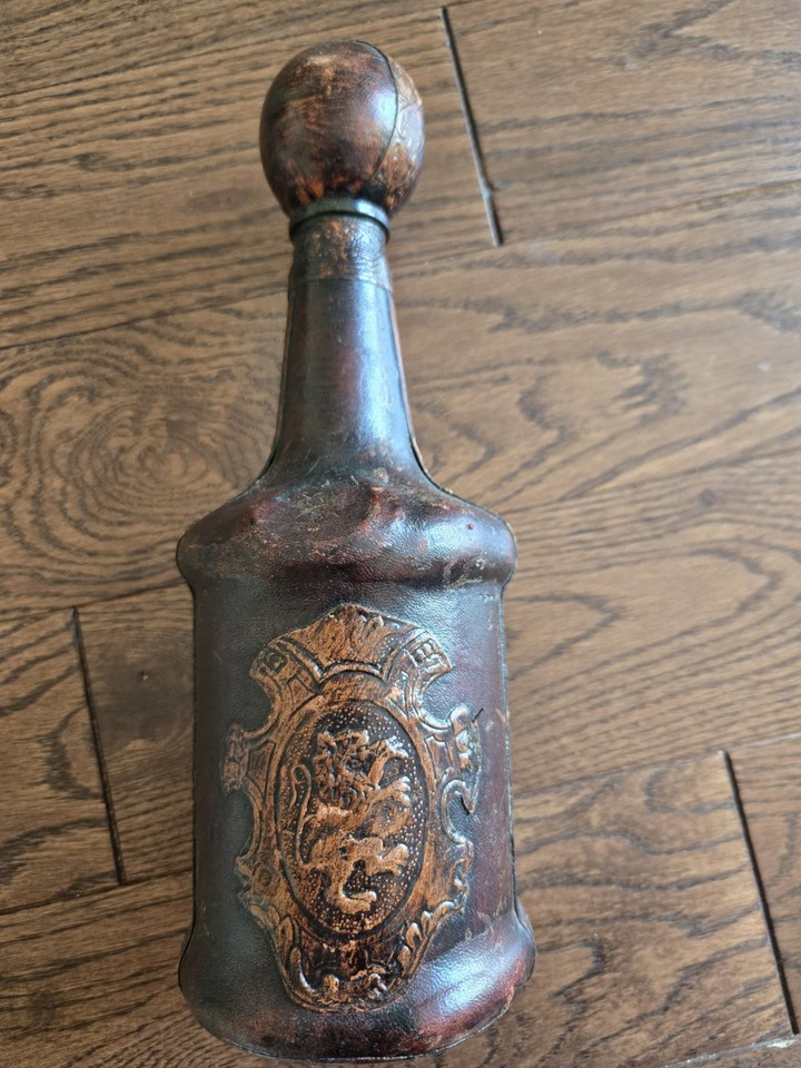 A hand-wrapped leather Italian liquor bottle that looks like a prop from a James Bond villain's study — tactile, striking, and totally unique.