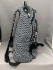 Black and white geometric print Kipling Seoul backpack with front zipper, monkey keychain, and textured fabric.