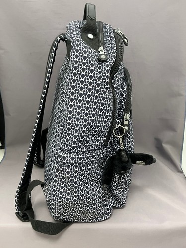 Black and white geometric print Kipling Seoul backpack with front zipper, monkey keychain, and textured fabric.