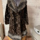 Brown vintage ILGWU winter coat with plush beige and black fur trim, large collar, and two front flap pockets.