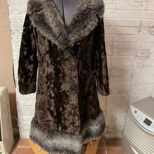 Brown vintage ILGWU winter coat with plush beige and black fur trim, large collar, and two front flap pockets.