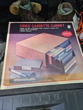 Vintage Video Cassette VHS Beta Storage Cabinet 22 Tapes Faux Wood New In Box.