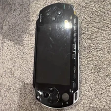 PSP 1000 Black With Capcom Classics And Charger Cord.