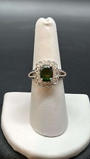 Gorgeous sterling ring with green center surrounded by clear stones Size 6.75