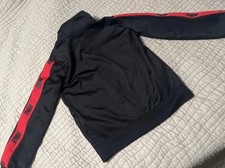 Nike boy  s jacket size 3-4 yrs . Black with red stripes. Front pockets .
