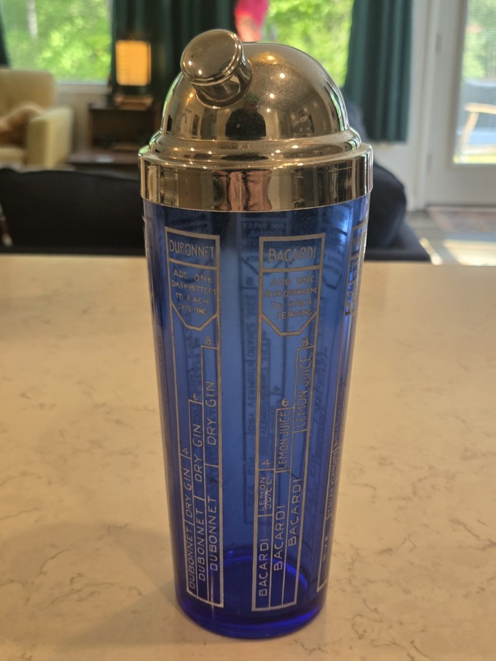 A genuine 1930s cobalt blue glass cocktail shaker that doubles as a piece of Depression-era art — the color alone stops people in their tracks.