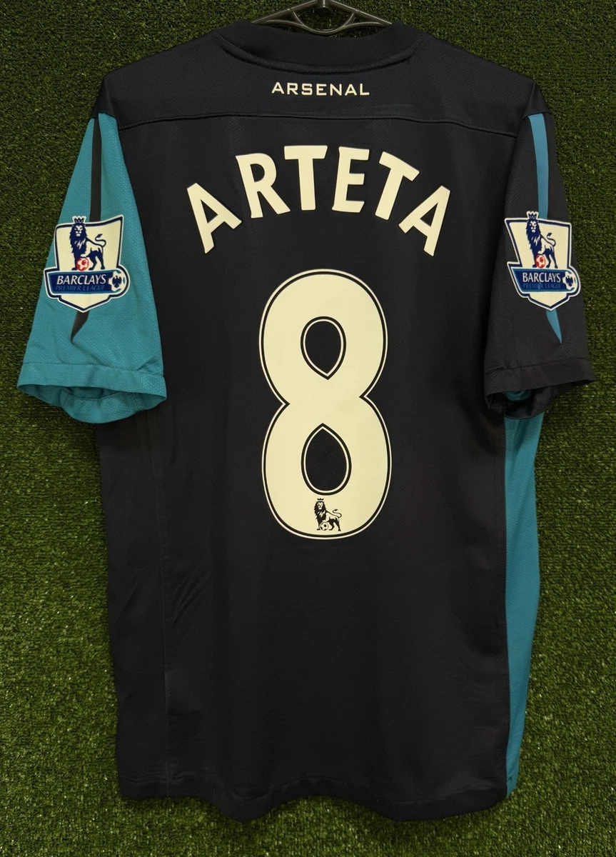 Preços baixos em Arsenal Blue International Club Camisas de