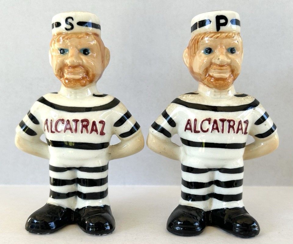 Figural salt & pepper shakers shaped like Alcatraz prisoners — a genuinely collectible, visually striking piece of mid-century novelty kitsch.