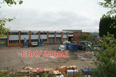 PHOTO  MODERN WORKS IN FRONT OF AN OLD LACE FACTORY THE SLATE ROOF PEEKING ABOVE