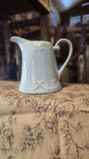 Simple Dining Creamer/Pitcher Tan colored with Raised Scrolling