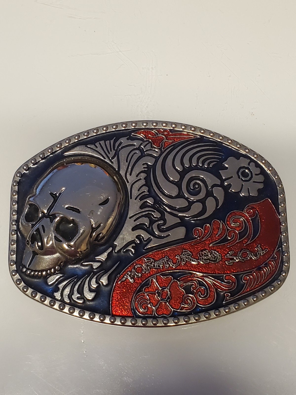Smiling Skull Belt Buckle With Black And Red Enamel Gem