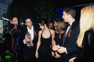 Matthew Perry wearing a black suit over a blue waistcoat white shi- Old Photo 1