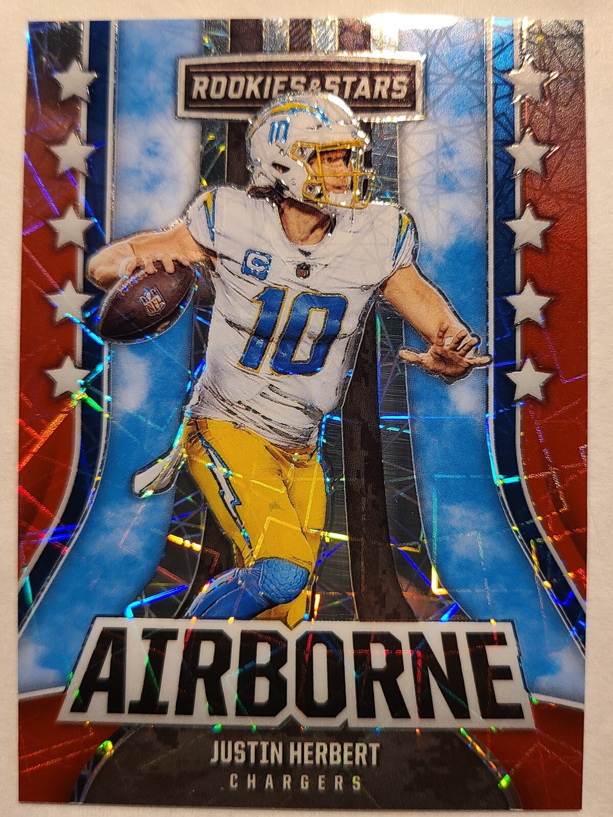 2023 Panini Rookies & Stars Justin Herbert AI-18 Red Laser Longevity Airborne