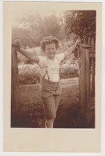 Timeless Happiness Young Boy Radiating Joy in the Sunlit Garden Gate Old Photo