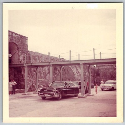 Vtg Color Snapshot 1958 Black Cadillac Car Parked By Old Stone Fort Wall 1960s