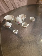 miniature or child's porcelain tea set with a floral pattern. Set For 2.