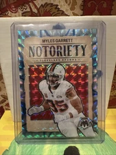 2024 Panini Mosaic Notoriety Myles Garrett #16 Reactive Blue Mosaic Prizm /99 SP