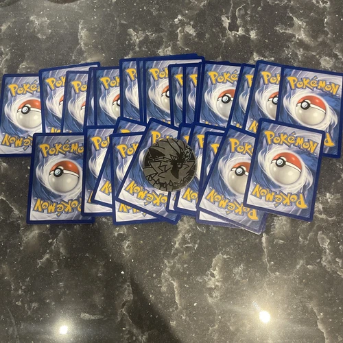 25 random Pokémon Cards And A Pokémon Coin