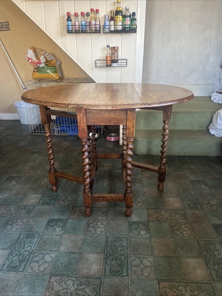 This is an antique oak gateleg drop-leaf table with barley twist legs ...
