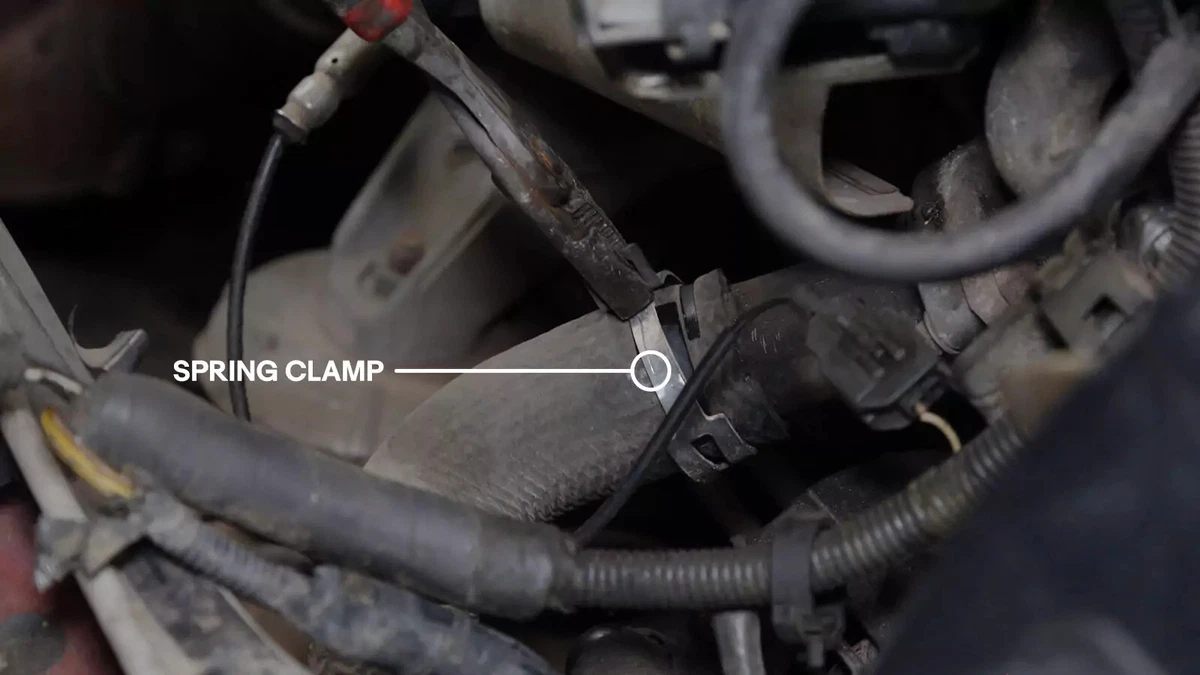 An arrow pointing to a radiator’s spring clamp.